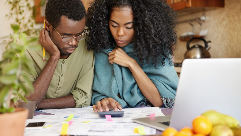 Couple sitting at a table looking at documents