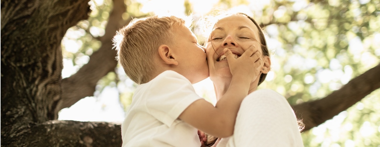 young son kissing mom