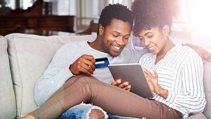 Couple with credit card and tablet