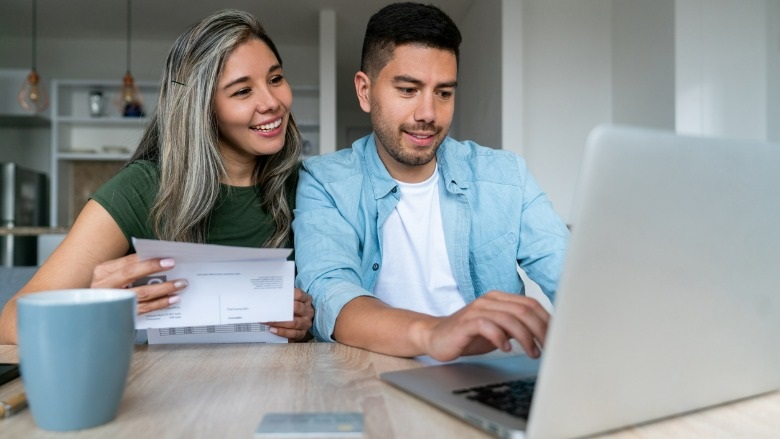 Couple at a table with a laptop