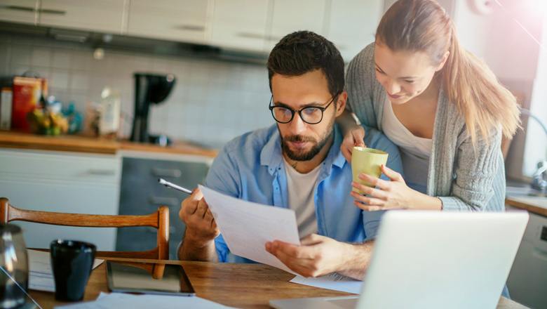Couple at kitchen table looking at a home equity loan